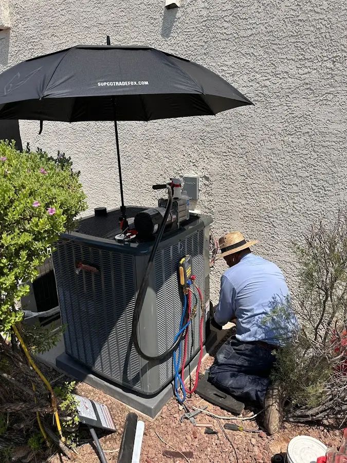 HVAC technician performing outdoor AC maintenance in Clinton